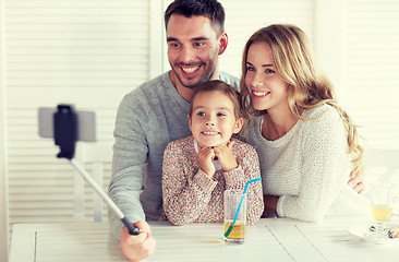 Image showing happy family taking selfie at restaurant