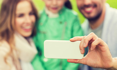 Image showing close up of family taking selfie by smartphone