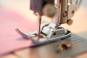 Image showing sewing machine presser foot stitching fabric
