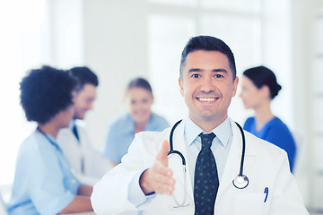 Image showing happy doctor over group of medics at hospital