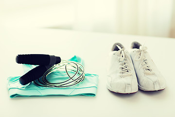 Image showing close up of sports top, sneakers and skipping rope