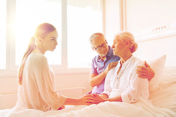 Image showing family visiting ill senior woman at hospital