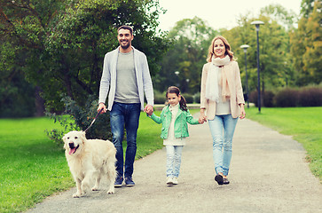 Image showing happy family with labrador retriever dog in park