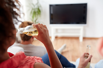 Image showing woman drinking beer and watching tv at home