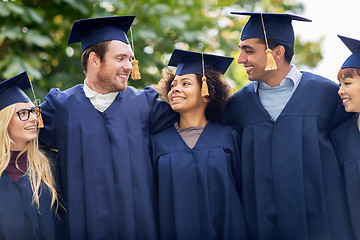 Image showing happy students or bachelors in mortar boards