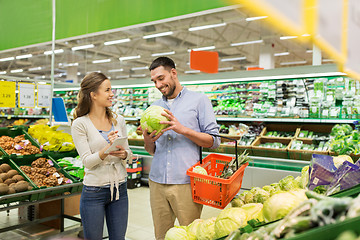 Image showing couple with food basket shopping at grocery store