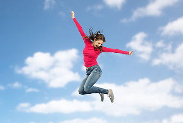 Image showing smiling young woman jumping in air