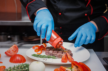 Image showing Chef set grilled meat