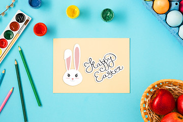 Image showing The top view of easter on blue table office workplace