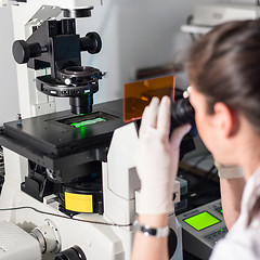 Image showing Life science researcher microscoping in genetic scientific laboratory.