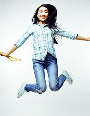 Image showing young pretty jumping asian woman posing cheerful emotional isolated on white background, lifestyle people concept