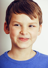 Image showing young pretty little cute boy kid wondering, posing face isolated on white background, gesture happy smiling close up, lifestyle real people concept