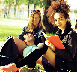 Image showing cute group of teenages at the building of university with books 