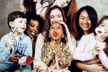 Image showing Lifestyle and people concept: young pretty diversity nations woman with different age children celebrating on birth day party together happy smiling, making selfie. African-american, asian and caucasi