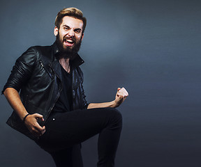 Image showing portrait of young bearded hipster guy smiling on gray background close up, brutal man, lifestyle real people concept copyspace