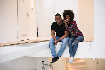 Image showing couple having break during moving to new house