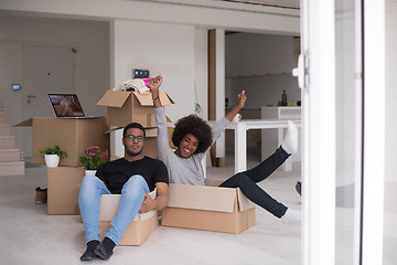 Image showing African American couple  playing with packing material