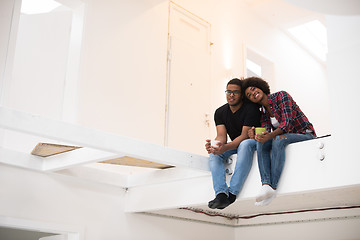 Image showing couple having break during moving to new house