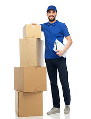 Image showing happy delivery man with parcel boxes and clipboard