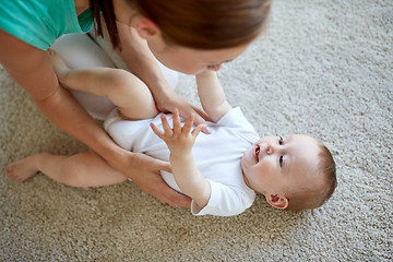 Image showing happy mother playing with baby at home