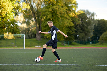 Image showing soccer player playing with ball on football field