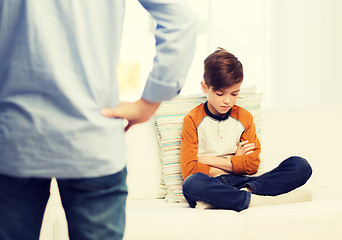 Image showing upset or feeling guilty boy and father at home