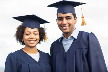 Image showing happy students or bachelors in mortar boards