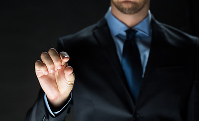 Image showing close up of businessman touching virtual screen