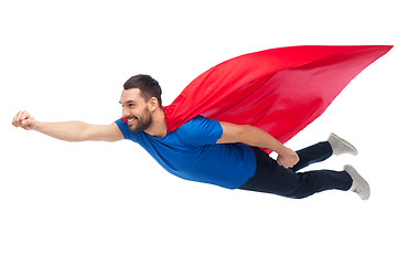 Image showing happy man in red superhero cape flying on air