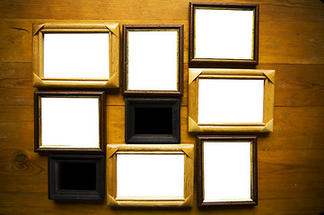 Image showing empty picture frames on wooden wall