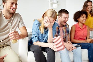 Image showing happy friends with popcorn and beer at home