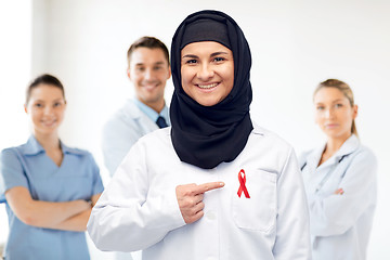 Image showing muslim doctor in hijab with red awareness ribbon