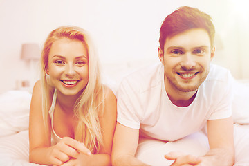 Image showing happy couple lying in bed at home