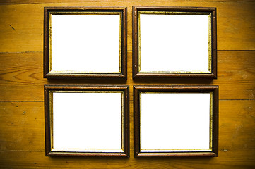 Image showing empty picture frames on wooden wall