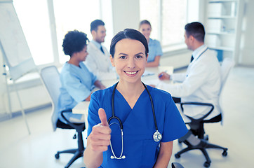 Image showing happy doctor over group of medics at hospital