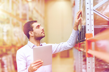 Image showing businessman with tablet pc at warehouse