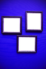 Image showing empty picture frames on blue wall