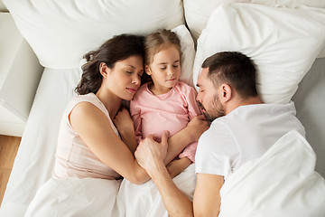 Image showing happy family sleeping in bed at home