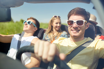 Image showing happy friends driving in cabriolet car