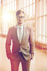 Image showing young businessman in suit and glasses at office