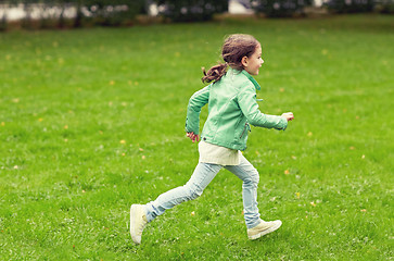 Image showing happy little girl running on green summer field