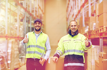 Image showing men with boxes showing thumbs up at warehouse