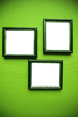 Image showing empty frames on green wall