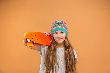 Image showing Pretty skater girl holding skateboard