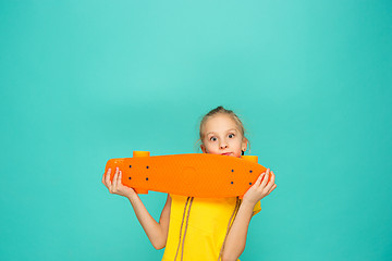 Image showing Pretty skater girl holding skateboard
