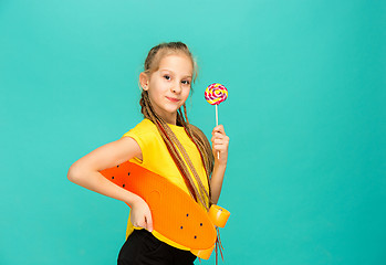 Image showing Pretty skater girl holding skateboard