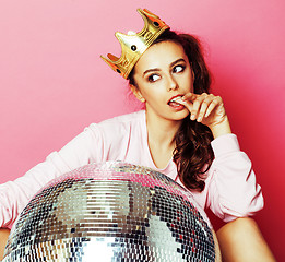 Image showing young cute disco girl on pink background with disco ball and cro