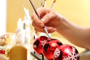 Image showing Female hand painted Christmas bauble in Christmas decorations factory 