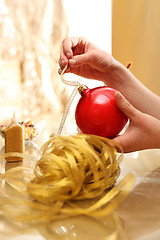 Image showing Christmas preparations, the woman preparing decorations. 