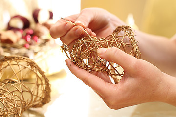 Image showing Christmas decoration, golden bells Golden bells made of sticks